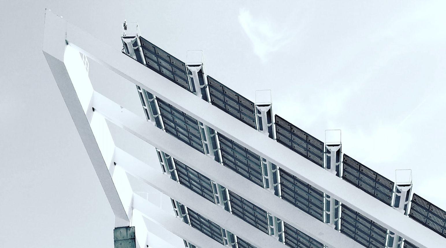 person under white and gray concrete structure during daytime photography